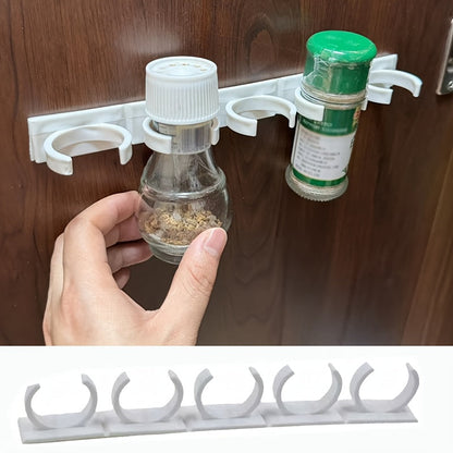 A convenient kitchen organizer, this spice bottle storage rack features a wall-mounted self-adhesive design that can be easily cut to size for simple installation and easy access to all your spices.