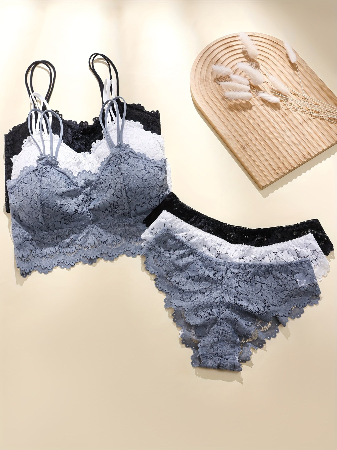 Sexy lingerie set includes cami bra and panties with solid floral lace for women.