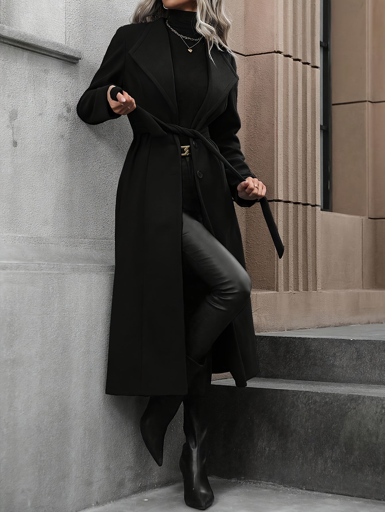 Stylish black trench coat with belt for women's fall/winter outerwear collection.