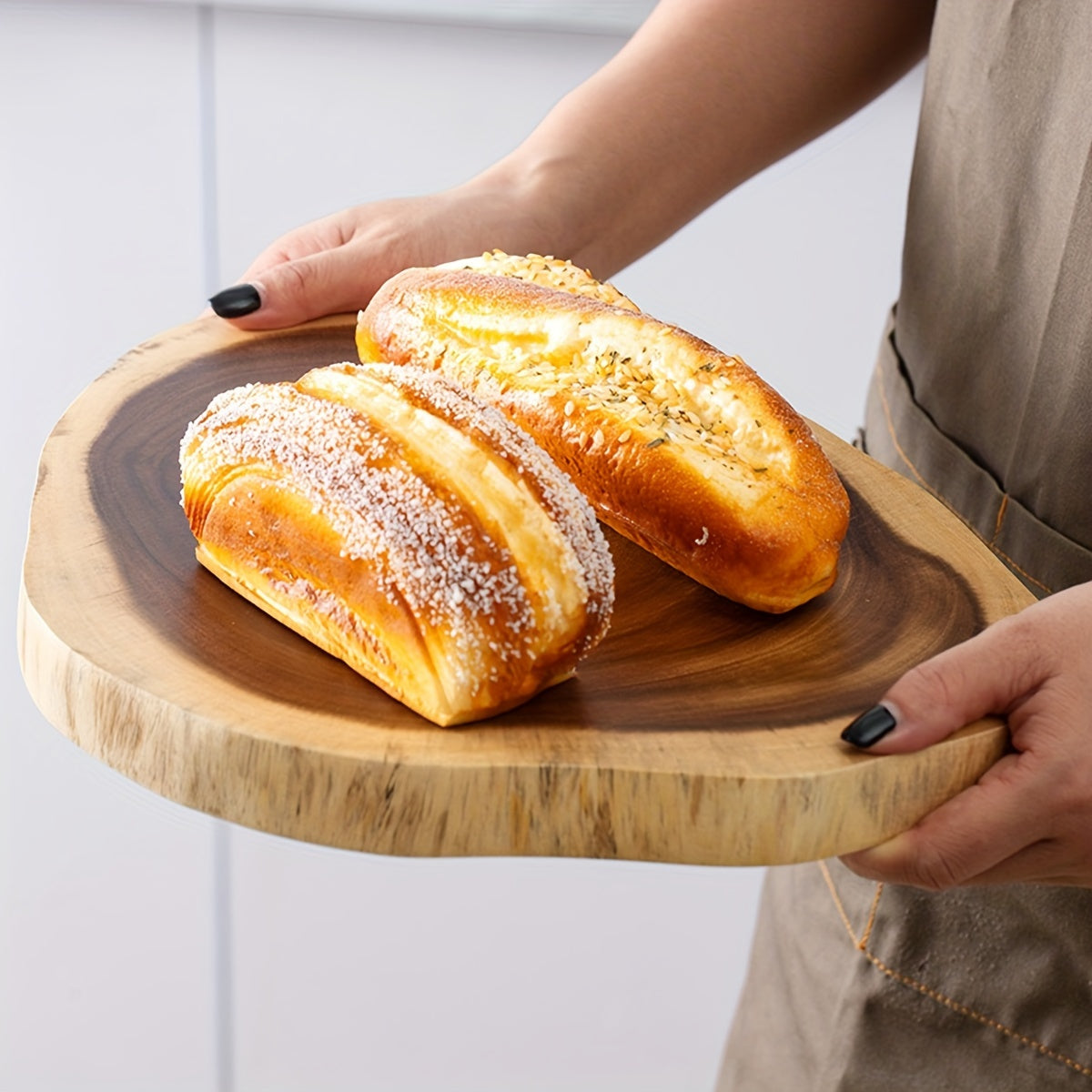 Set of one Acacia wood cutting board, made from organic whole wood. This serving platter features a natural edge perfect for charcuterie and cheese. The food-safe chop block is ideal for cutting fruits, vegetables, and bread.