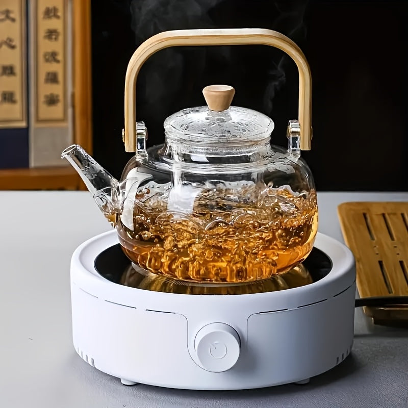 Glass teapot with bamboo handle and removable infuser, 34oz capacity. Made of heat-resistant clear borosilicate glass. Ideal for brewing loose leaf tea.