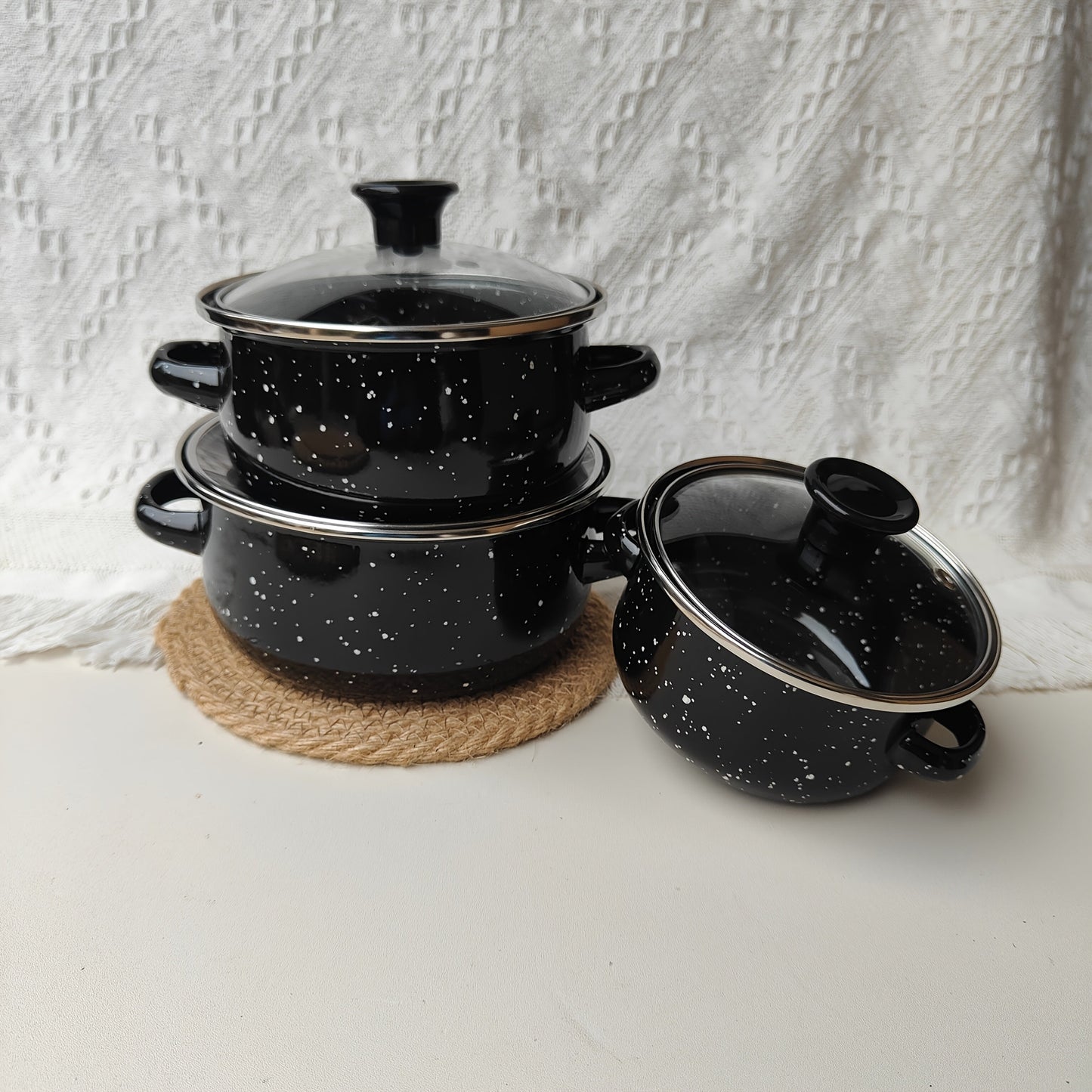 Enamel Pot Set includes three pieces with 12/14/16 cm mini pots in a solid color, speckled design - ideal for cooking delicious meals at home.