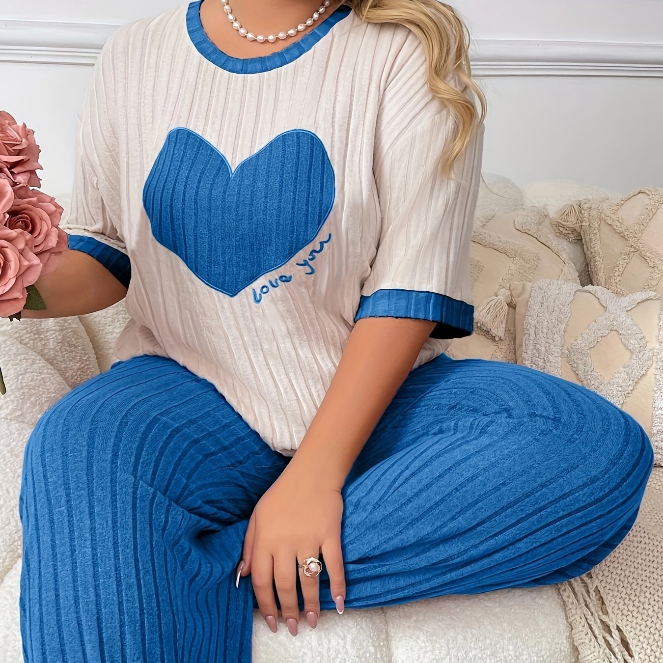 Cozy heart embroidered pajama set in plus size, includes short sleeve top and long pants made of soft polyester. Machine washable.