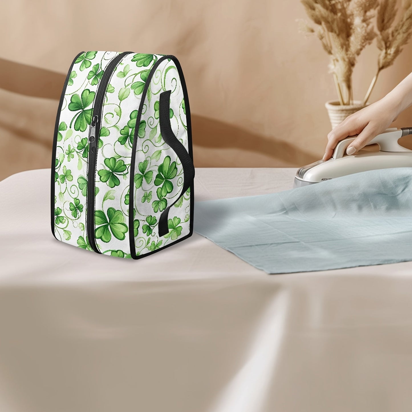 Portable ironing bag with St. Patrick's Day cloverleaf design, perfect for travel or storage. Features top handle and double zipper for easy access. Made of polyester material, dust proof. Ideal holiday gift for anyone in need of a stylish accessory.