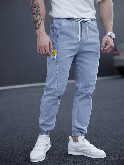 Trendy men's tapered jeans with waist drawstring