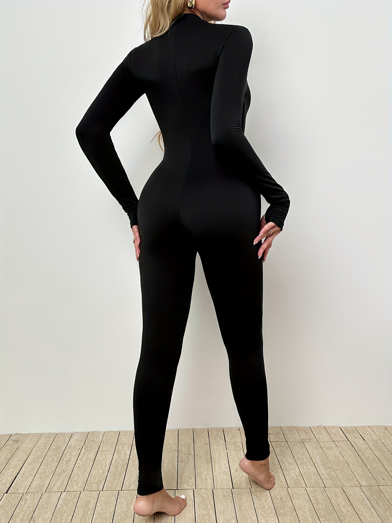 Slim-fit long sleeve jumpsuit for women, ideal for workouts.