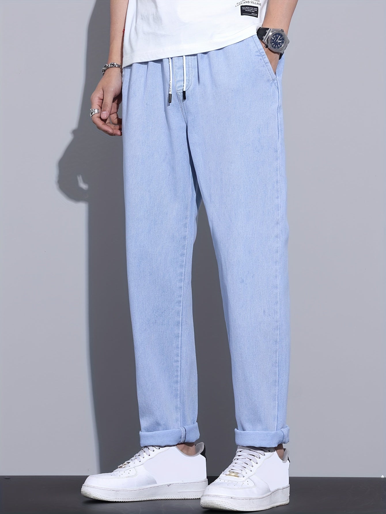 Men's light blue drawstring waist straight-leg jeans in glossy fabric, perfect for all seasons.