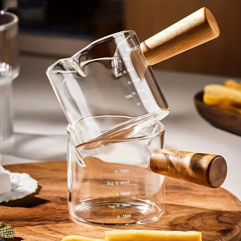 Small and stylish, this 2oz measuring cup features a heat-resistant glass body and a convenient wooden handle for easy use. With dual spout, scale markings, and ideal for measuring small quantities, this cup is perfect for both coffee and kitchen use.