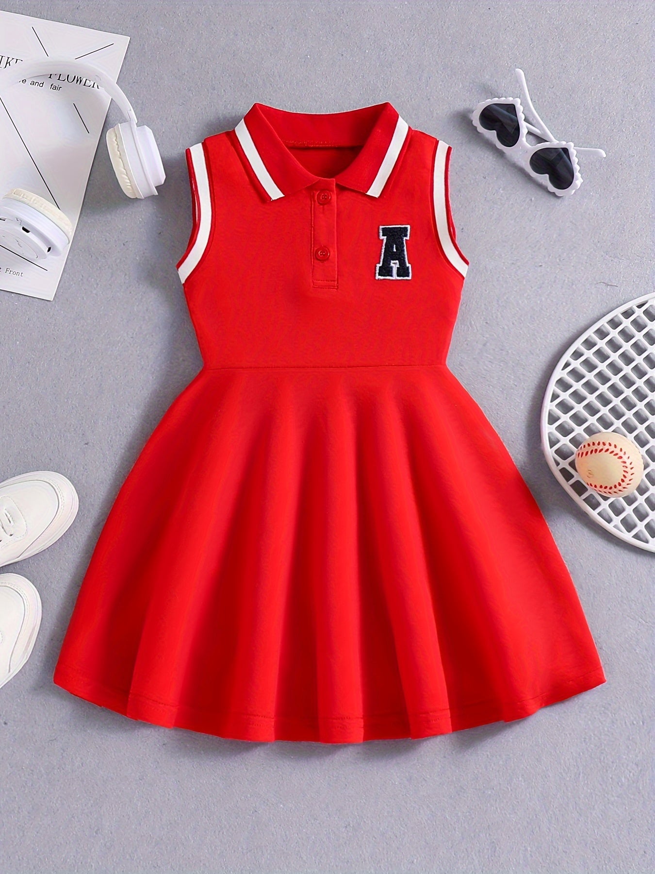 Girls' Red Tennis & Athletic Dress in sporty elegance featuring breathable, sweat-absorbent polyester with stretch and sleeveless design with black lettering for sports and casual wear.