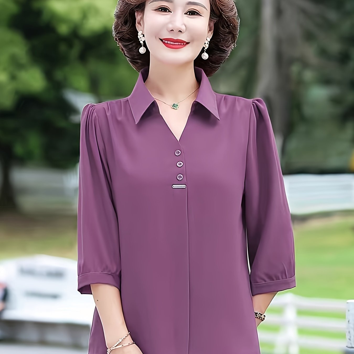 Stylish purple chiffon blouse for women with 3/4 sleeves, slimming fit, and decorative buttons. Made of lightweight polyester-elastane blend, perfect for spring, summer, and fall. Features