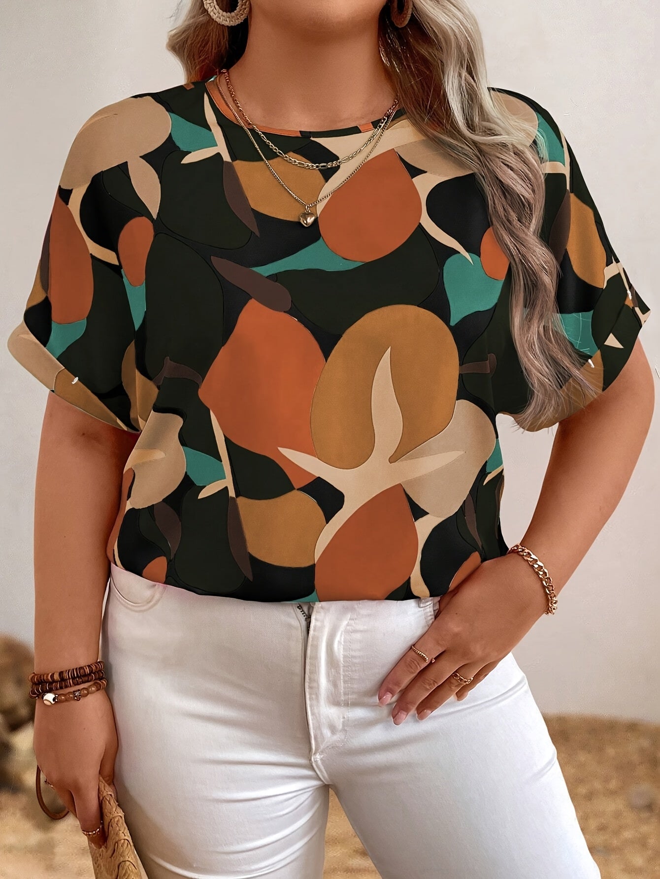 Plus size floral print batwing sleeve blouse in orange, brown & green camouflage design for women. Casual crew neck summer top.