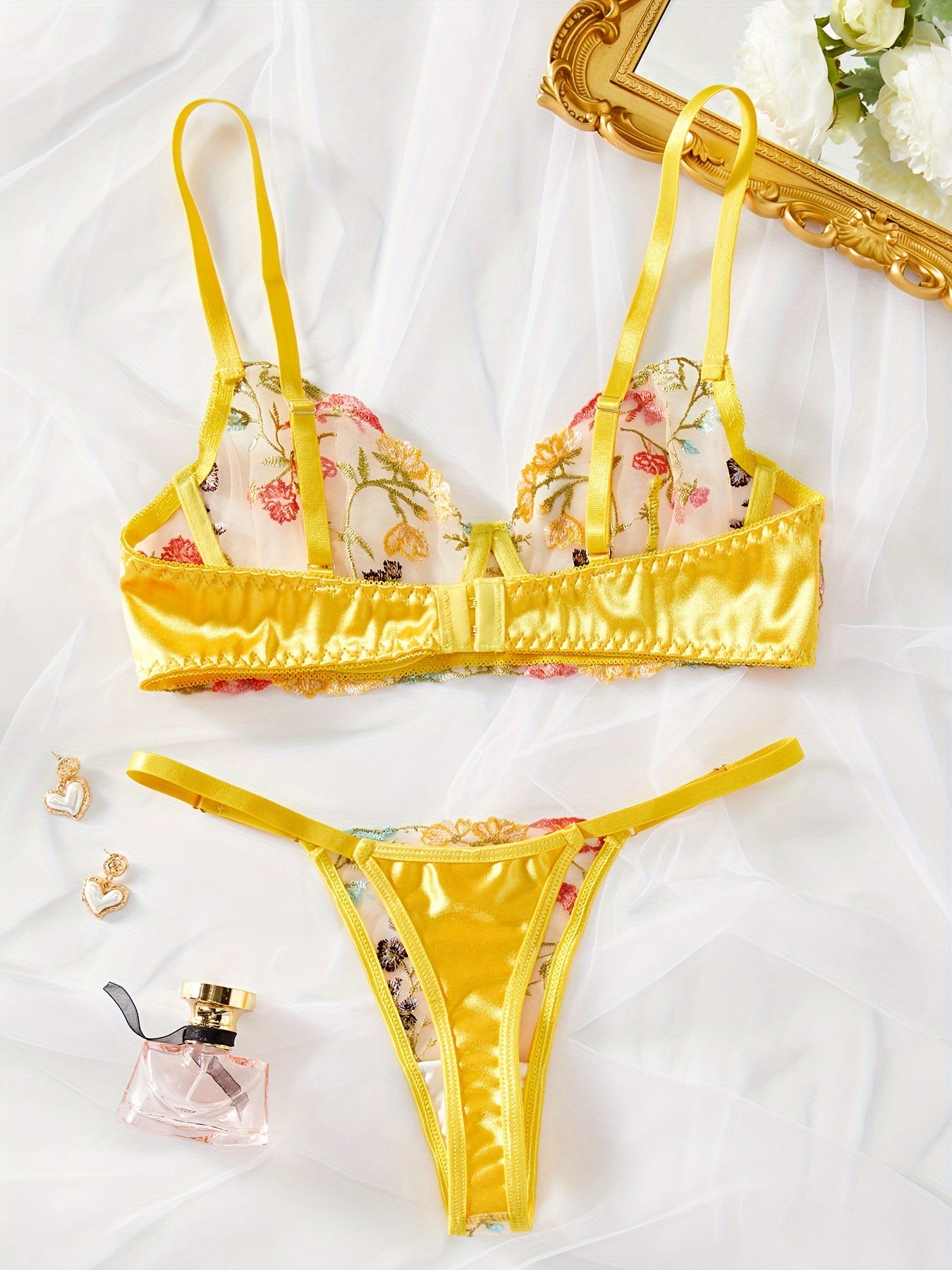 Yellow semi-sheer mesh lingerie set with floral embroidery, including bra and thong. Perfect for a stylish and sexy look.