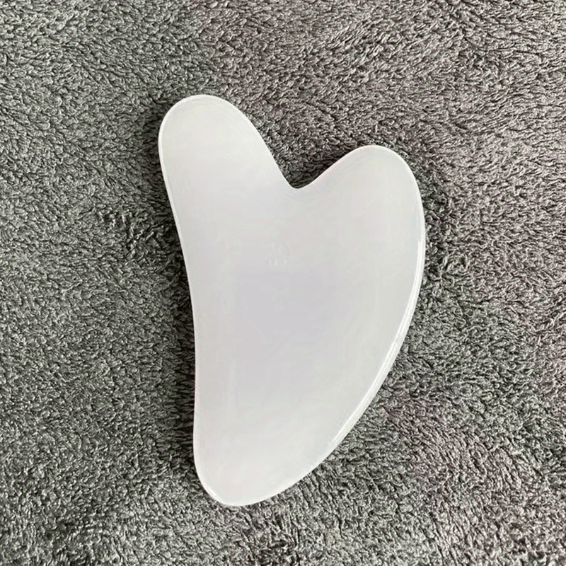 Heart-shaped resin Gua Sha tool for facial and full body hair removal, high-quality for beauty salon use.