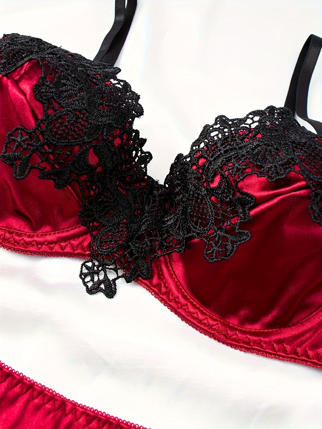 Embroidered satin lingerie set with garter belts.