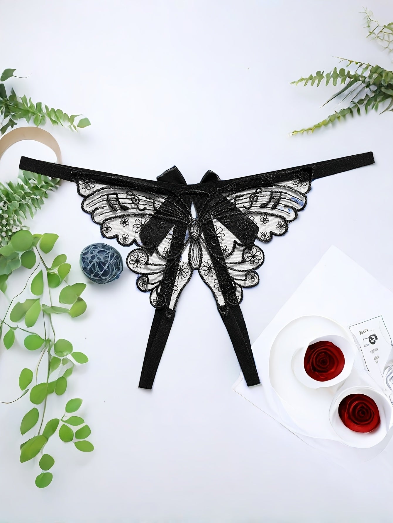 Adults' elegant butterfly embroidery mesh thong with split crotch and bow detail, made of knit fabric.