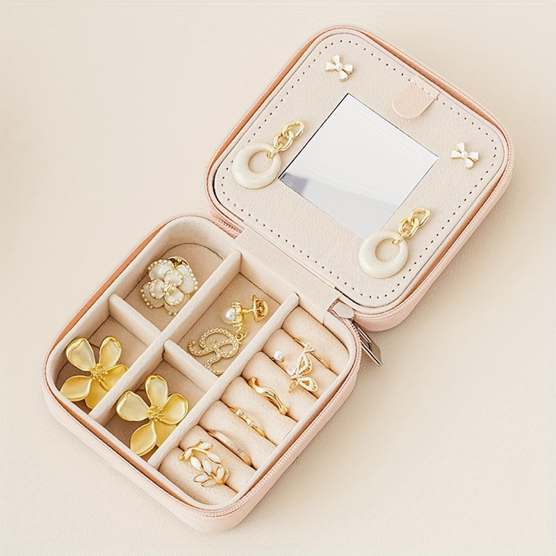 Compact and stylish portable jewelry box with mirror, zipper, and flip cover. Ideal for storing rings, earrings, and necklaces on-the-go.