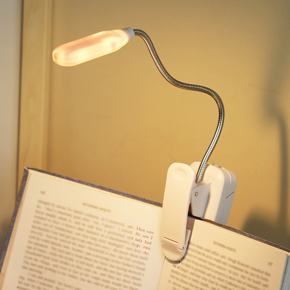 Portable battery-powered space-themed book light with adjustable arm, push button control, and uplight lighting, ideal for bedside use.