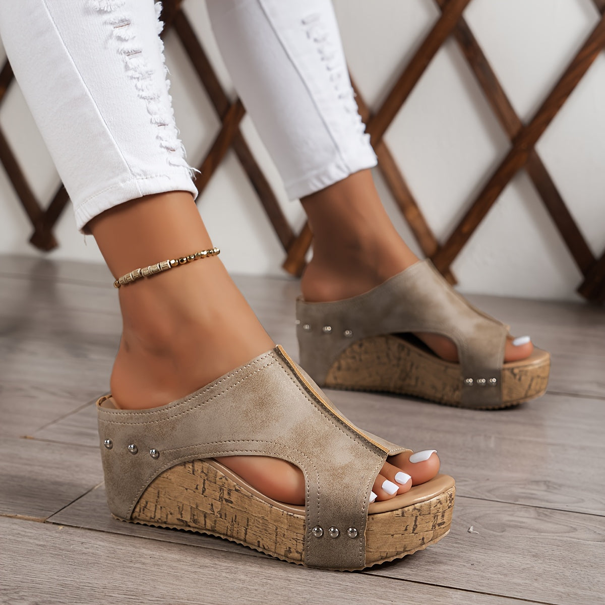 Women's platform sandals with studded decor and wedge heel.