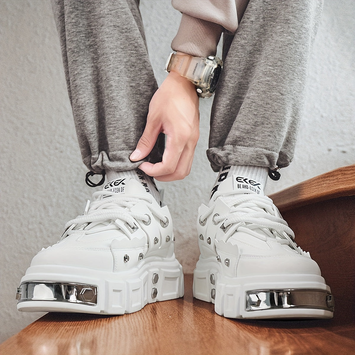 Chunky, punk-inspired sneakers with metal stud accents. Streetwear fashion statement in white, thick-soled trainers. Ideal for skateboarding, parties, and everyday wear. Unisex.