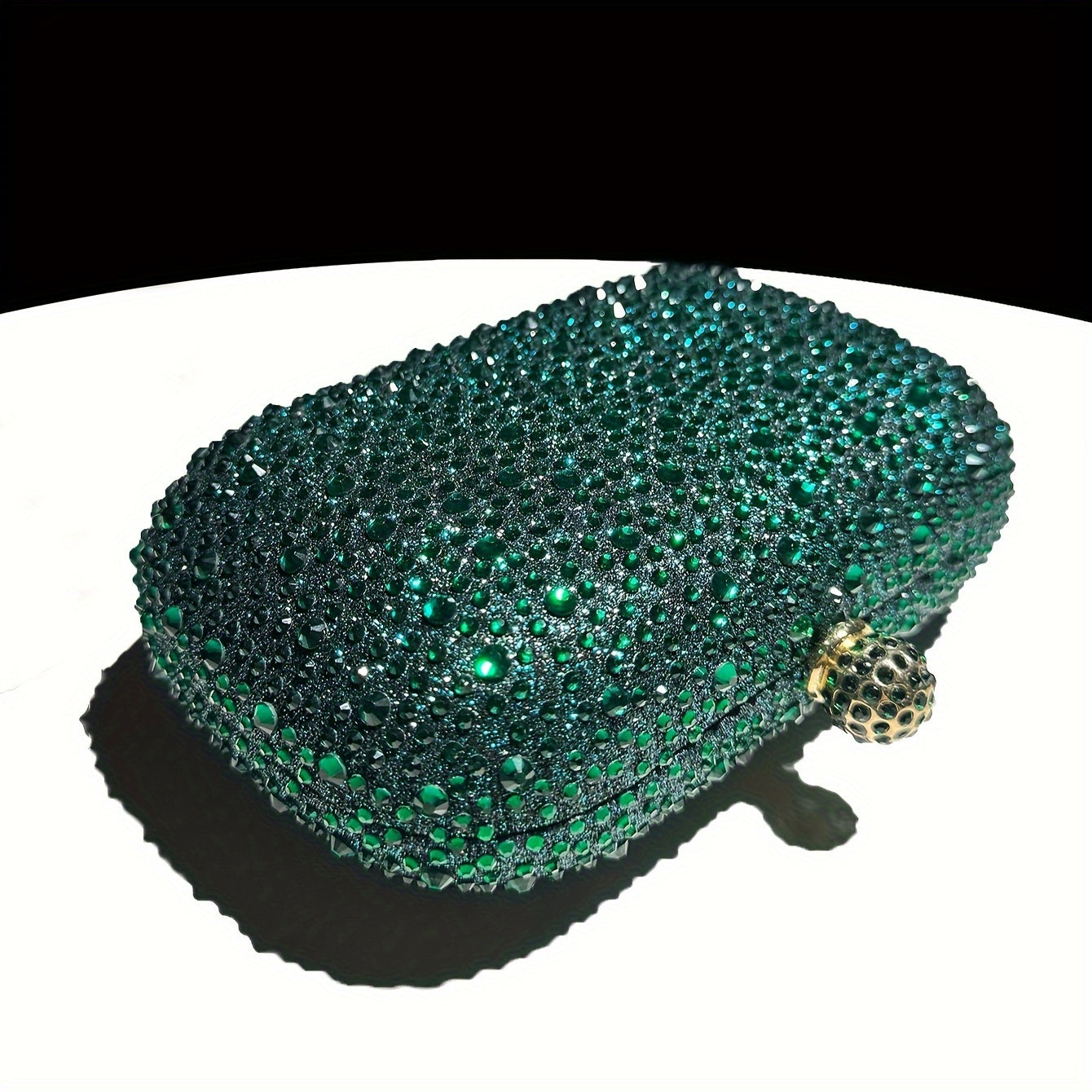 Stylish emerald green handbag with golden chain, suitable for formal events and as a gift for women.