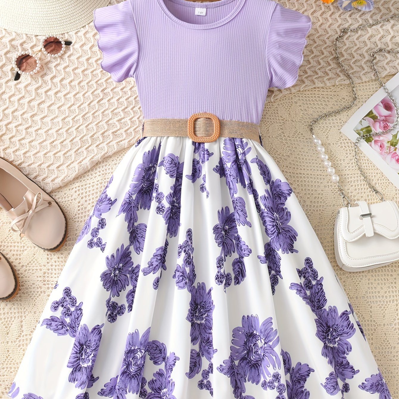 Summer floral dress for girls with ruffle sleeves, knee-length, polyester knit fabric, elastic waist belt, and flared hem in lavender & white floral print. Crew neckline and A-line