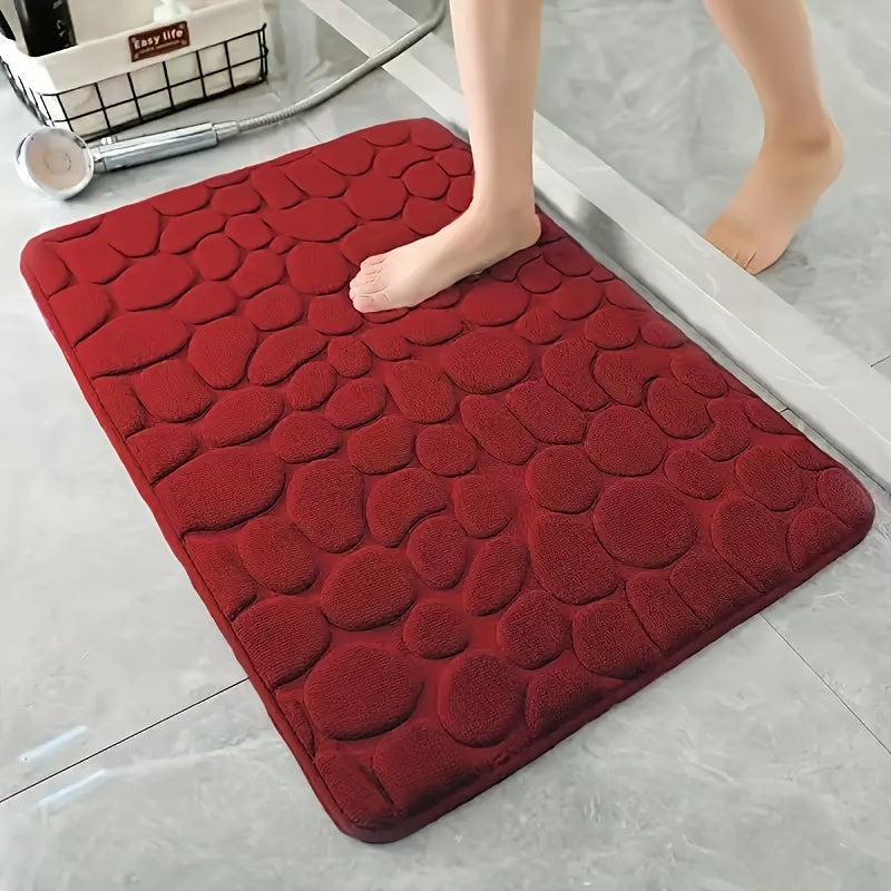 Luxurious red memory foam bath mat with geometric pattern for bathroom floors. Non-slip, soft polyester material that is quick-drying and absorbent. Hand washable, fragrance-free with a textured surface and machine-knit design. Perfect for a quick dry