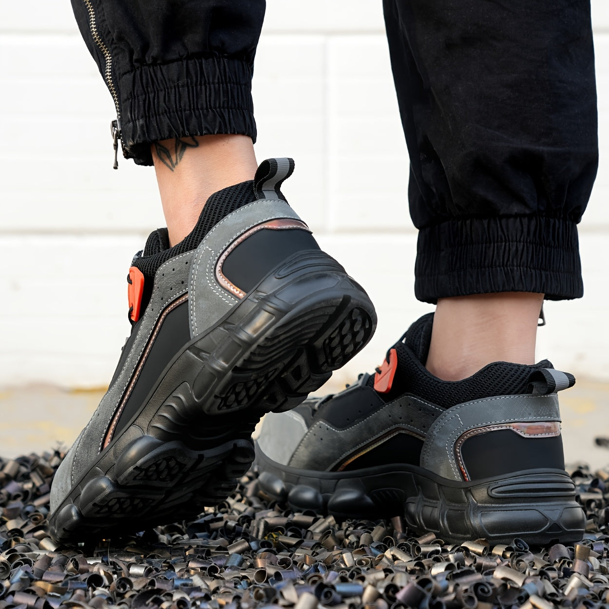 Steel toe work shoes with breathable design, puncture-resistant sole, and durable fabric upper in gray/black/orange. Perfect for construction and industrial tasks.