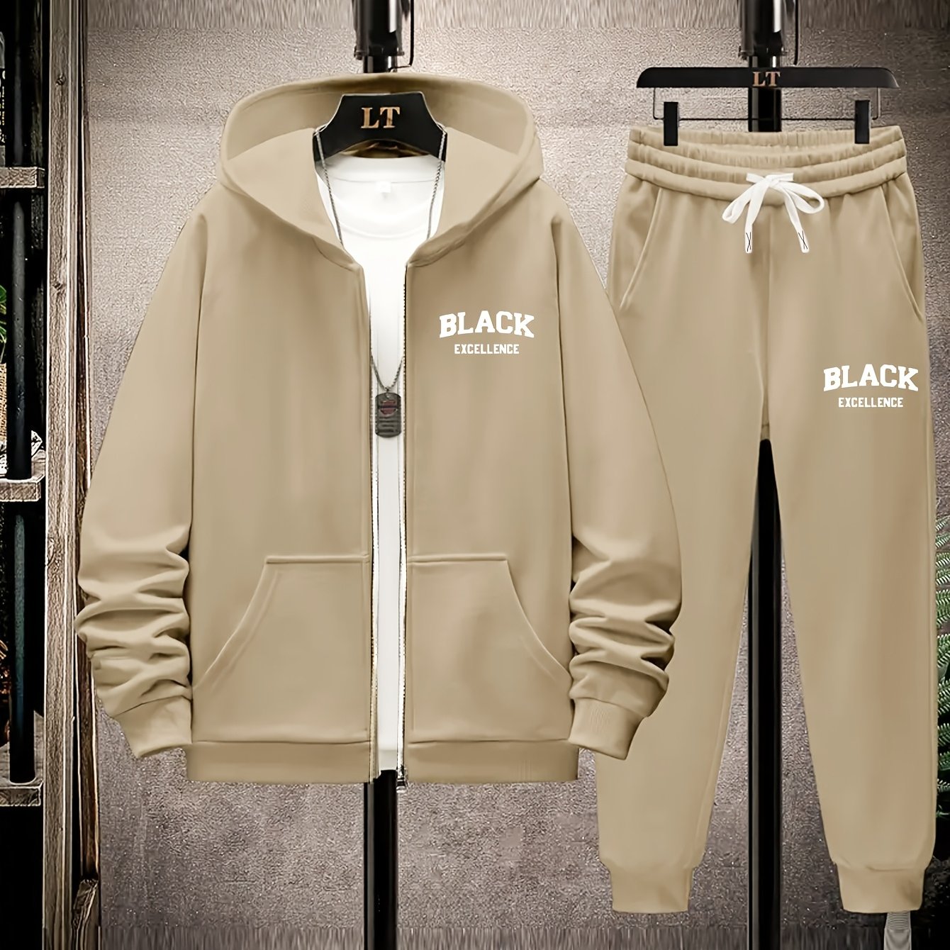 Polyester knit tracksuit set with black alphabet print and metal chain detail, ideal for fall/winter. Features slight stretch for a comfortable fit.