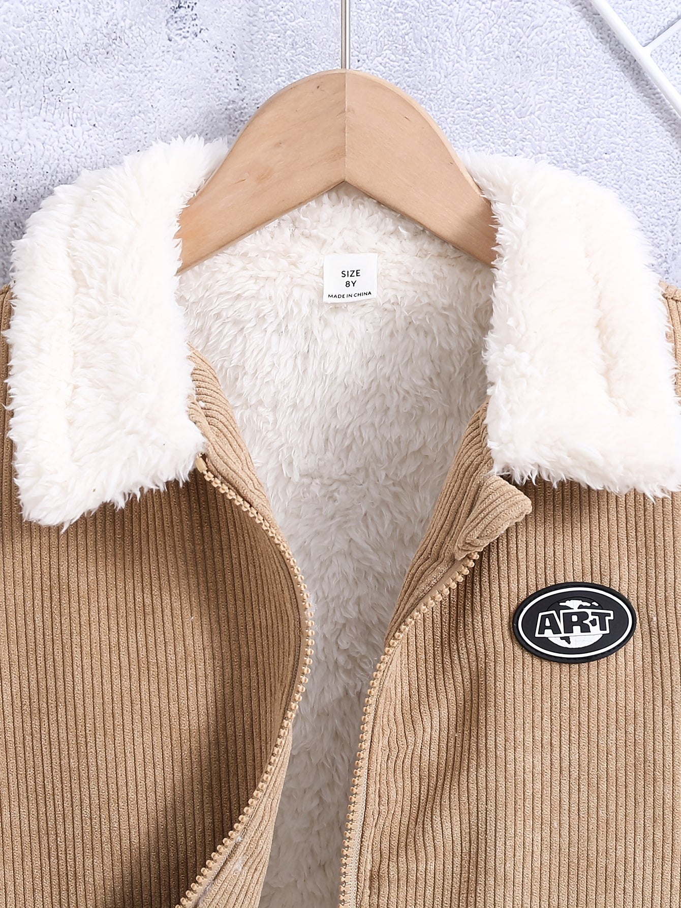 Boy's warm jacket with thick fleece lining, ideal for fall and winter outdoor wear.