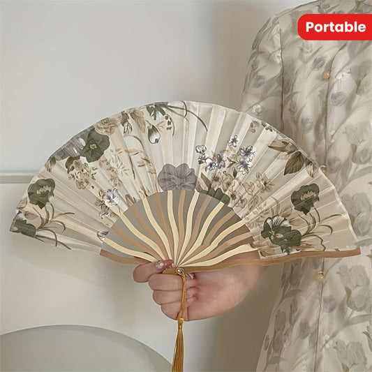 Vintage style folding fan with traditional Chinese ink painting, made of bamboo fabric. This elegant accessory features a beautiful floral pattern and tassel, perfect for adding a touch of retro charm to your summer qipao outfit. Ideal for both home