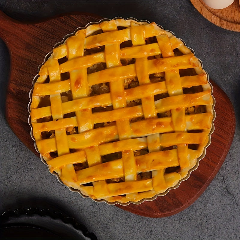 One piece of a round, black baking pan with a removable metal bottom and non-stick coating, perfect for baking pies, cakes, or cheese. Ideal for kitchen tools.