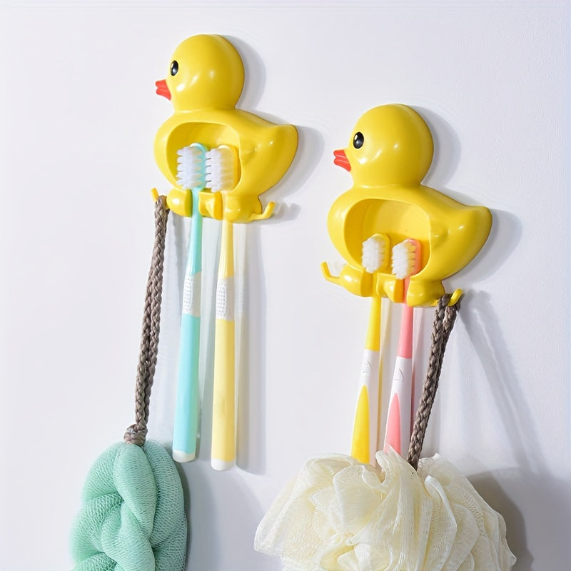 Wall-mounted toothbrush holder with cute duck design, waterproof plastic organizer with suction cup, no-drill installation, home decor.