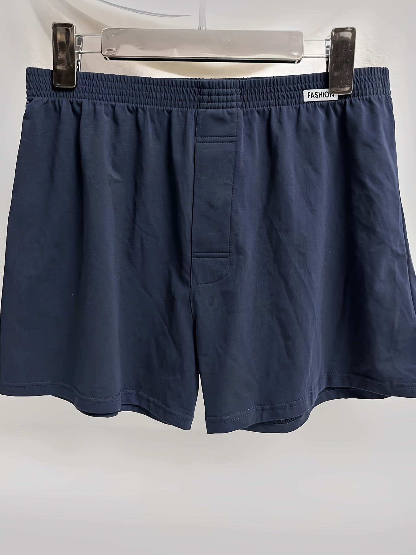 Three men's cotton boxer briefs in black, navy, and light blue with elastic waistband and no-ride design.