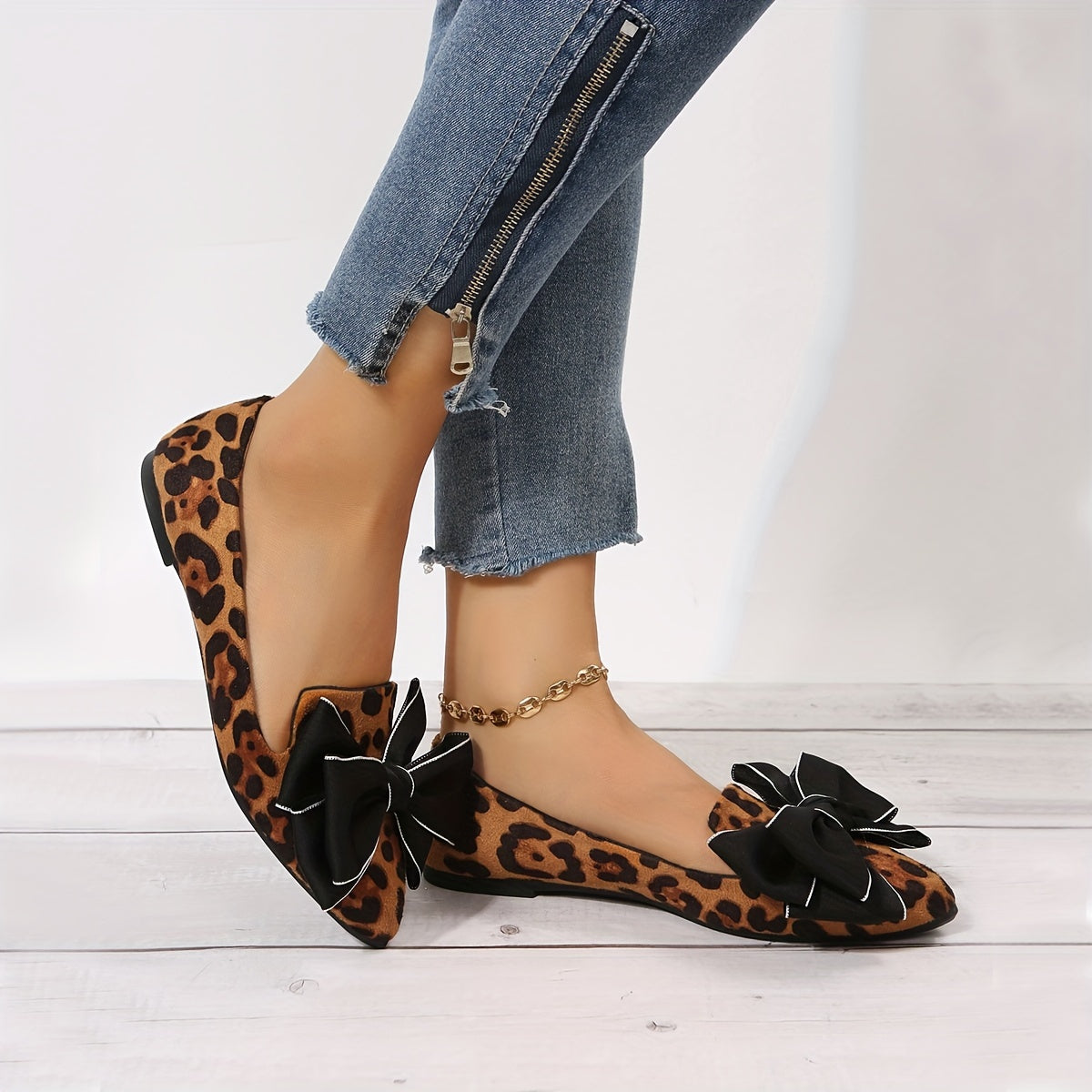 Leopard print flat shoes with bowknot decor and point toe, lightweight slip on style.