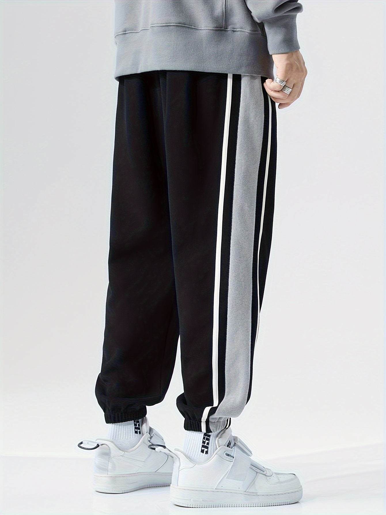 Men's loose sports pants for summer and fall, trendy style, available in large sizes, suitable for casual wear.