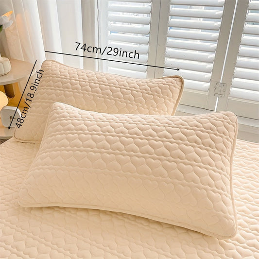 Two quilted pillowcases with waterproof lining, designed to be thick, oil-resistant, and machine washable in a stylish white and light gray color. Featuring an envelope closure, these pillowcases measure 48.26x76.2 cm and are perfect for home, hotel, or