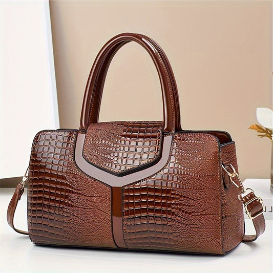 Women's luxury handbag with crocodile pattern, adjustable shoulder strap, glossy brown finish, elegant design, zipper closure, and versatile style.