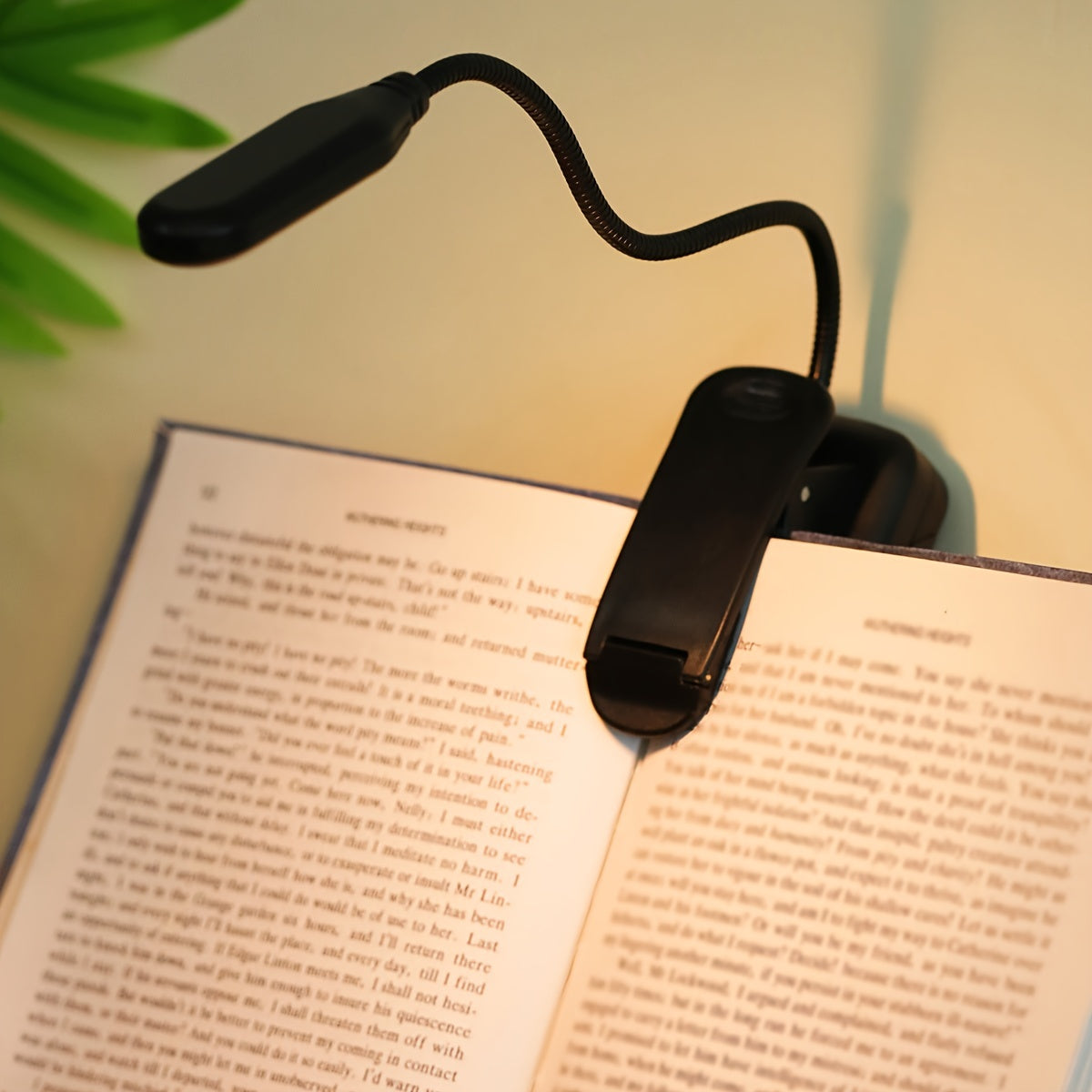 Portable battery-powered space-themed book light with adjustable arm, push button control, and uplight lighting, ideal for bedside use.