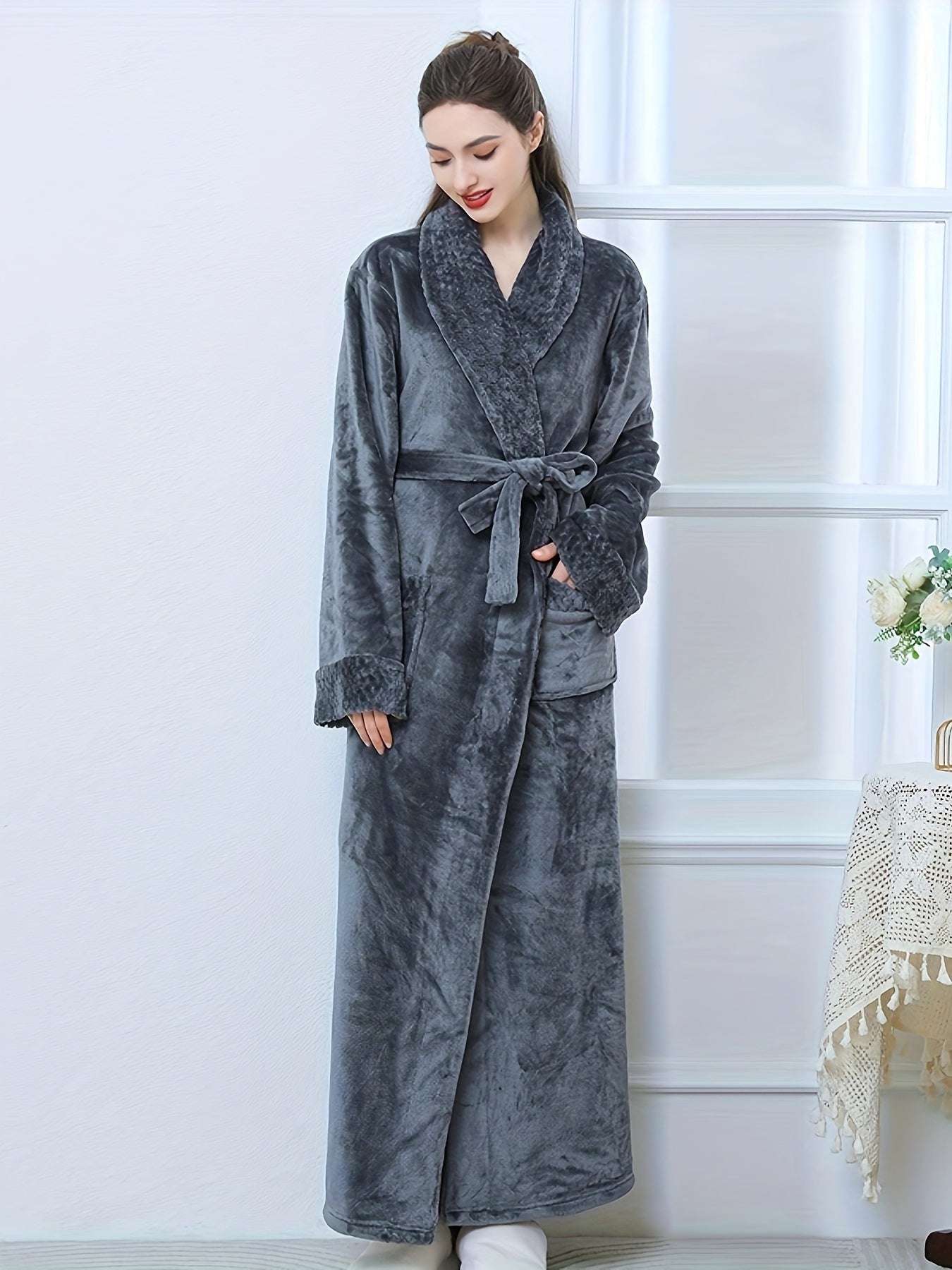 Plush pink flannel bathrobe for women with long sleeves, V-neck, and pockets. Machine washable for winter warmth.