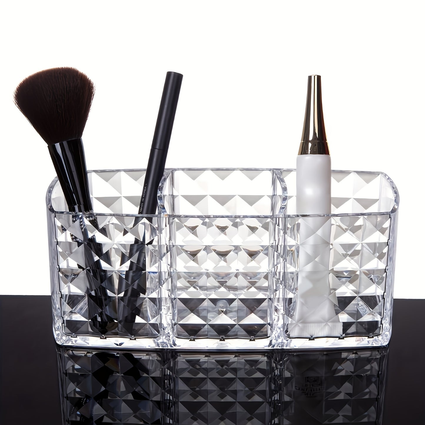 Clear plastic makeup organizer with 3 compartments for cosmetic storage. Ideal for brushes, lipsticks, brow pencils, and remote control. Can be used as a vanity or desk organizer without electricity.