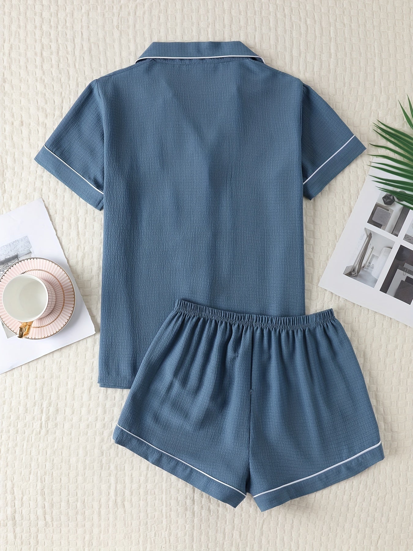 Basic pajama set for women, featuring a short-sleeve button-up top with lapel collar and elastic shorts.