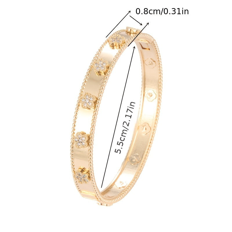 This elegant bangle bracelet is inspired by French design and features a beautiful golden tone with floral print and cubic zirconia accents. It is a classic copper hand jewelry piece perfect for daily wear and music festivals, showcasing a stylish plant