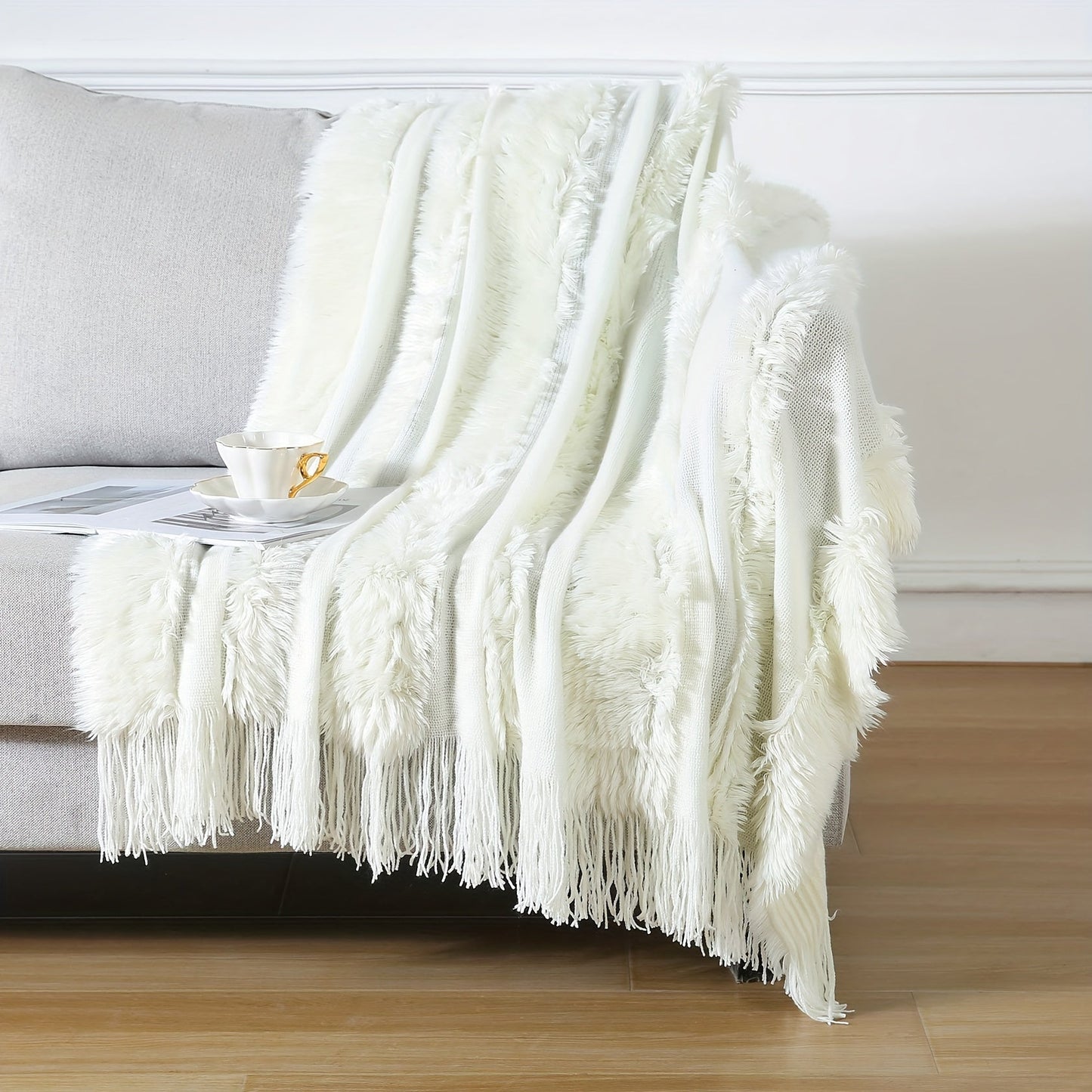 Stay cozy with this contemporary acrylic chunky knit throw blanket featuring tassels. With its solid pattern, lightweight plush texture, and machine washable design, this all-season throw is perfect for adding a touch of style and comfort to your couch