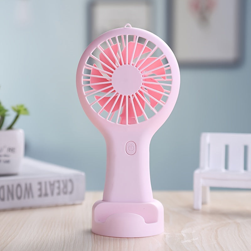 Compact and wearable mini fan for travel, office, outdoor, and home use. This handheld fan is portable, USB rechargeable, and includes a 400mAh lithium battery.