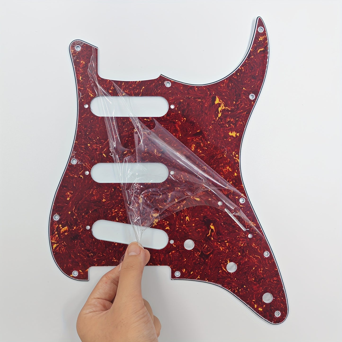 ST electric guitar single pickup guard with 11 holes, installation screws, and aluminum foil shielding. Fits standard FD ST style guitars, available in multiple colors.