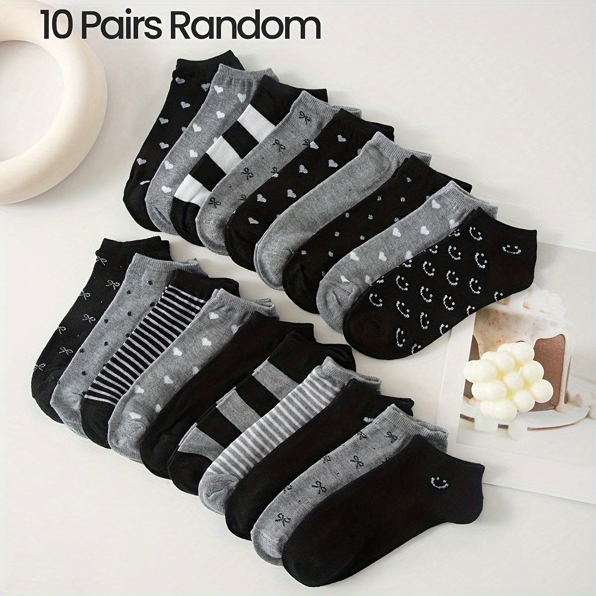 Women's ankle socks in black and grey with assorted geometric patterns. Made from comfortable knit fabric, 95% polyester and 5% spandex. Random style shipping. 10/20 pairs available.