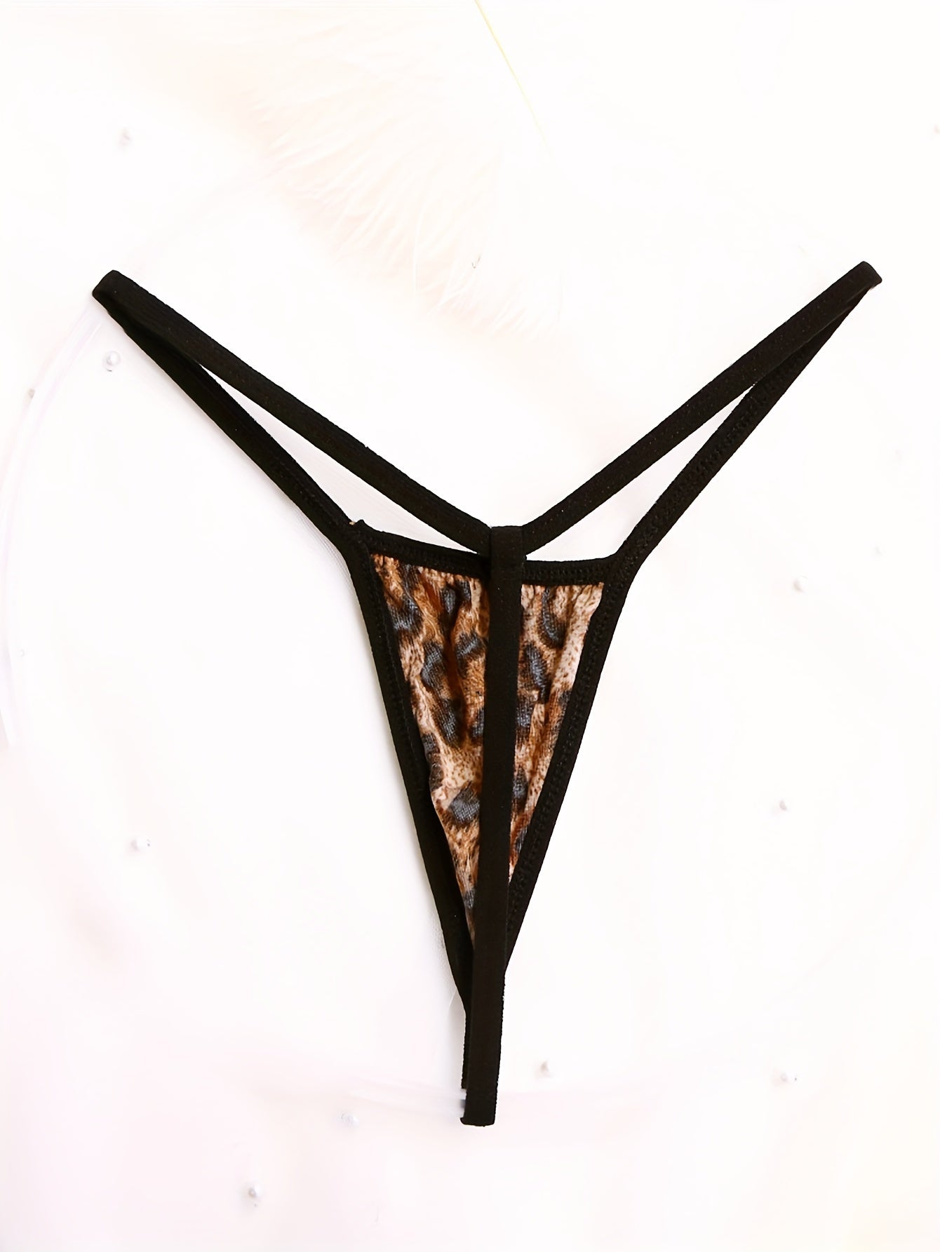 Seductive low-rise thong panties for women made with breathable nylon blend, featuring cross detail and semi-sheer sexy style.