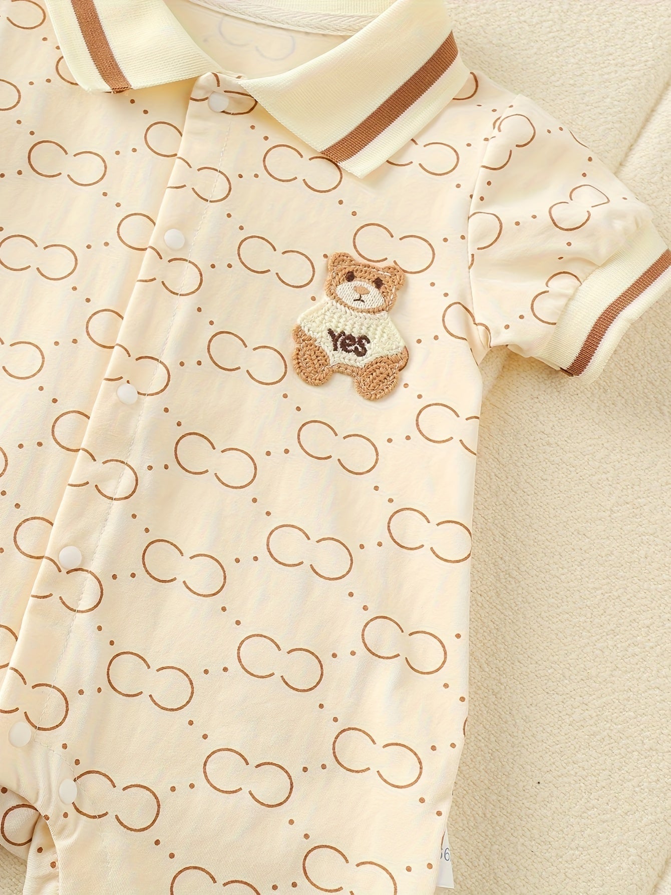 Cute bear-themed cotton romper for baby girls, perfect for summer outdoor wear, with short sleeves and a mechanical collar.