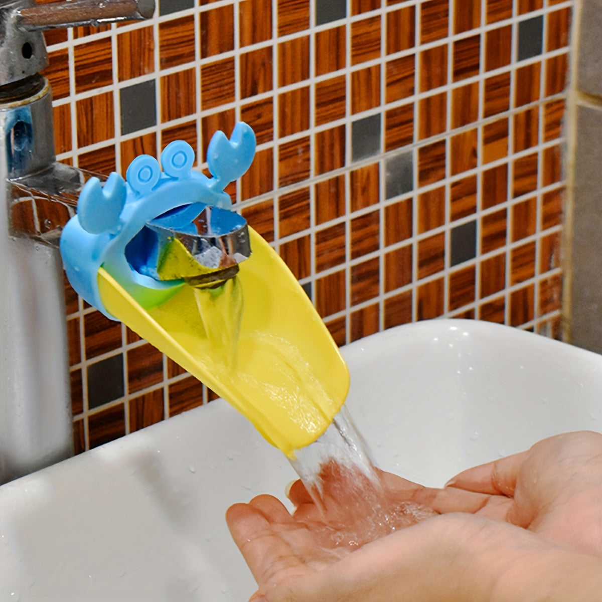 Crab-shaped water spout for kids makes hand washing fun with cartoon design.