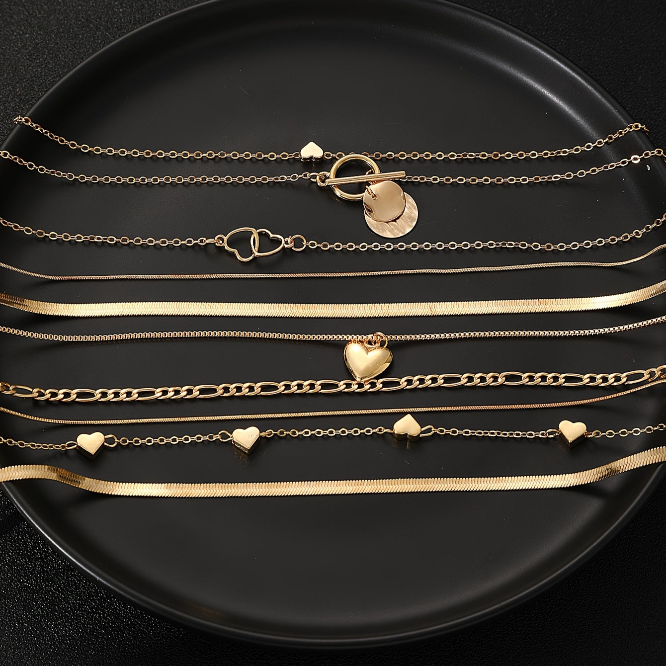 This stylish necklace set features 10 pieces with vintage heart and geometric pendants, complete with a snake chain and OT clasp. Ideal for everyday wear, special occasions, and gifting, this pendant necklace is the perfect accessory.